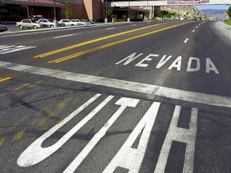 White line on street divides the economically disparate towns of West Wendover, Nev., and Wendover, Utah.
