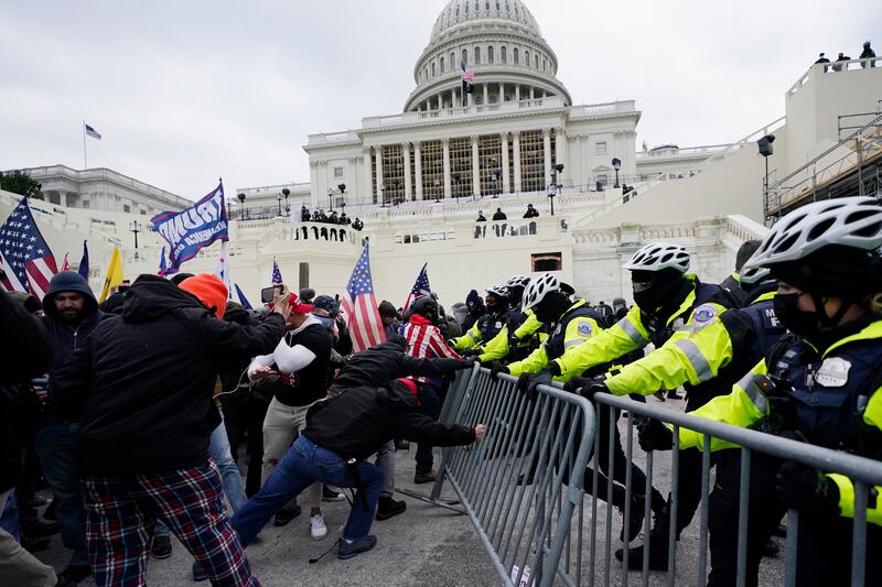 Insurrectionists try to break through a police barrier on Wednesday, Jan. 6, 2021, at the Capitol in Washington.