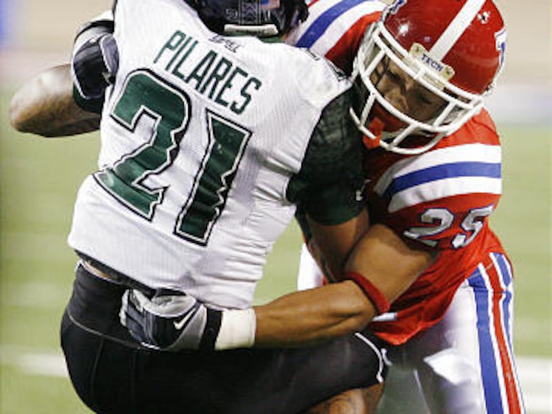Louisiana Tech University safety Deon Young (25) tackles Hawaii wide receiver Kealoha Pilares (21) during first half action at Joe Aillet Stadium in Ruston, La. on Wednesday.