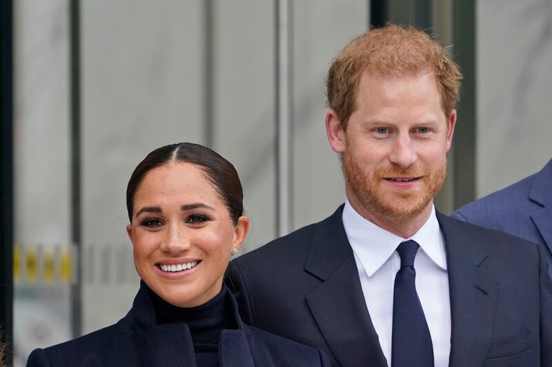Meghan Markle and Prince Harry pose for pictures after visiting the observatory in One World Trade.