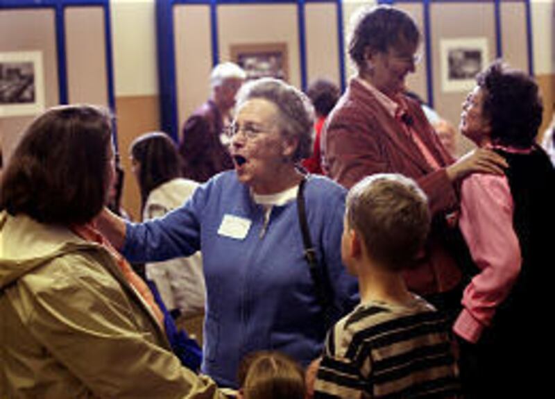 Heidi Boss, left, laughs with Ramona Heslop, Boss' kindergarten teacher from 1975, at the party.