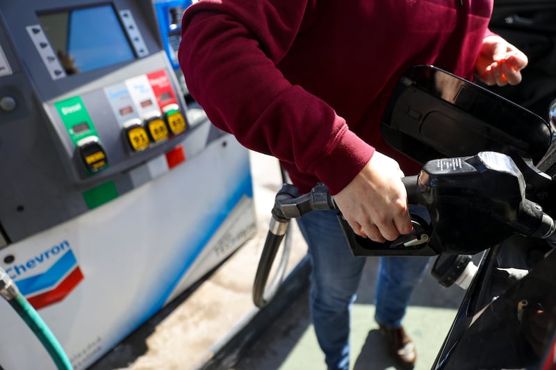 A driver pumps gas at a Chevron in Salt Lake City on Monday, March 7, 2022.