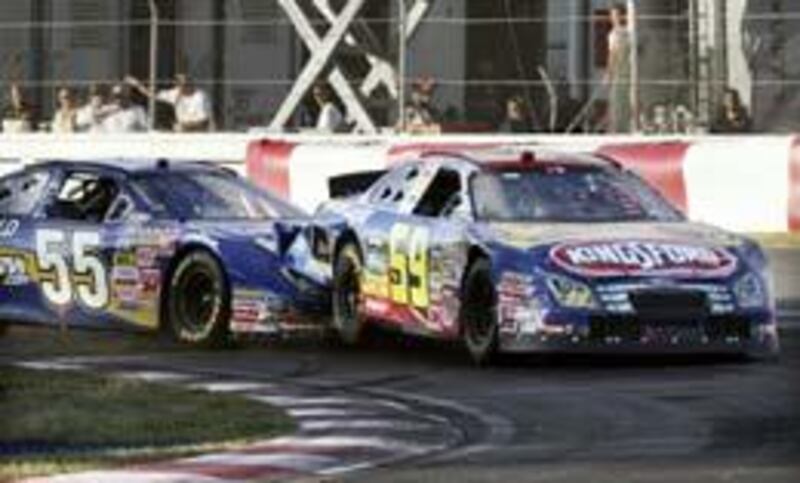 Robby Gordon (55) runs into the back of race leader Marcos Ambrose during the final laps of the NAPA Auto Parts 200 in Montreal, Canada, last Saturday. Gordon was black-flagged for the incident.