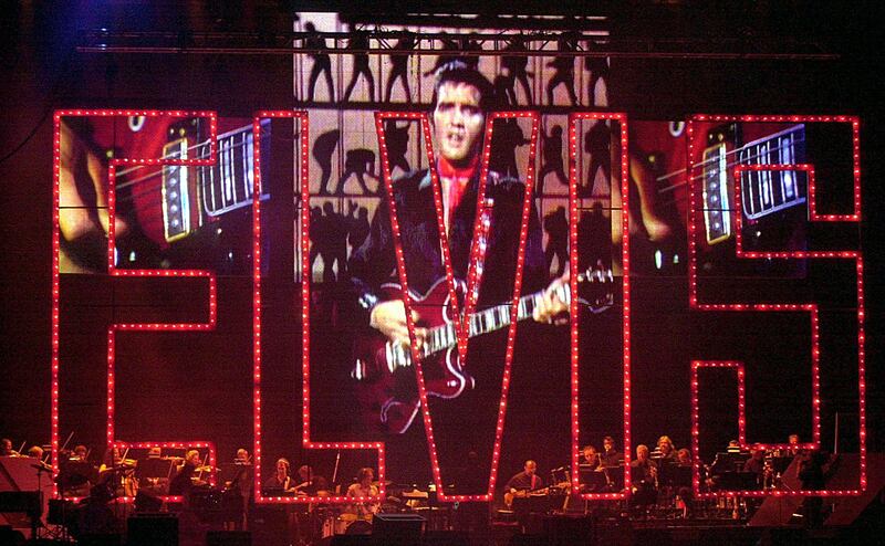 The late Elvis Presley sings via projection screen at the Elvis Presley 25th Anniversary Concert in Memphis, Tennessee.