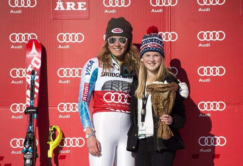 Winner Mikaela Shiffrin of the US, left, celebrates with her fan Emma Lundell on the podium after the women's FIS Alpine Ski World Cup slalom in Are, Sweden, Saturday March 14, 2015. After outclassing her opponents to win her fourth World Cup slalom race