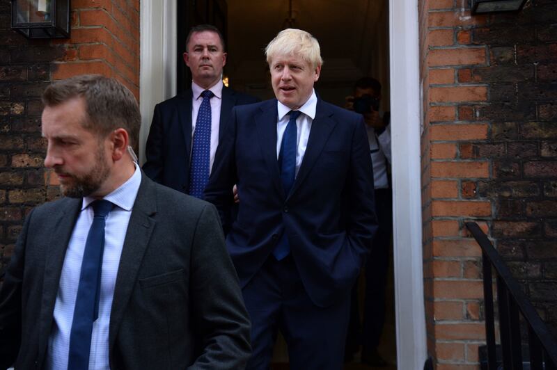 Boris Johnson, right, leaves his office in London on Monday, July 22, 2019.