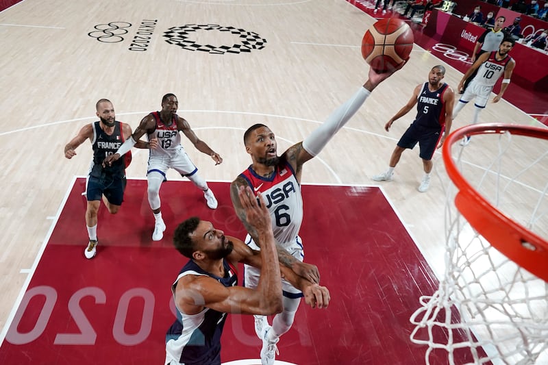 United States’ Damian Lillard drives to the basket over France’s Rudy Gobert
