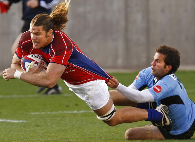 USA's Todd Clever dives for try and seven points at a international rugby match between as he is pulled down by Uruguay's Matias Arocena.