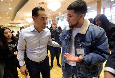 FILE - West High School junior Erick Hernandez, right, asks presidential candidate and former Secretary of Housing and Urban Development Julián Castro about his views on citizenship pathways for immigrants after Castro spoke at the University of Utah on W