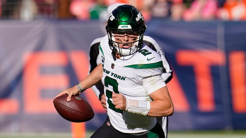 New York Jets quarterback Zach Wilson (2) runs out of the pocket against the Denver Broncos Sunday, Oct. 23, 2022.