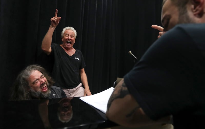 Air Supply’s Graham Russell, center, and musical director Jonathan Ivie, left, sing the high notes they want actor John Patrick McKenna to hit during rehearsal for the musical “A Wall Apart.”