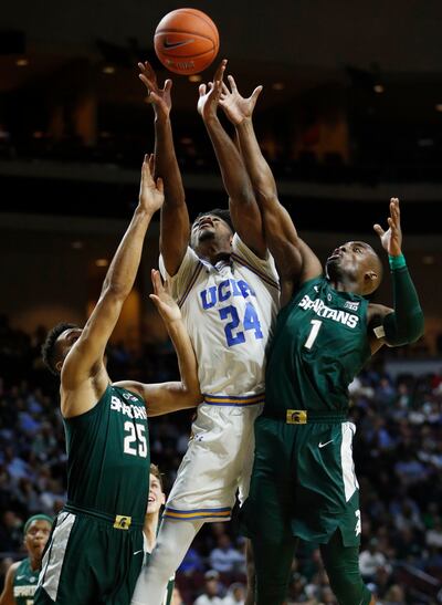 Michigan State's Kenny Goins (25), UCLA's Jalen Hill (24) and and Michigan State's Joshua Langford (1) reach for a rebound during the first half of an NCAA college basketball game Thursday, Nov. 22, 2018, in Las Vegas. (AP Photo/John Locher)