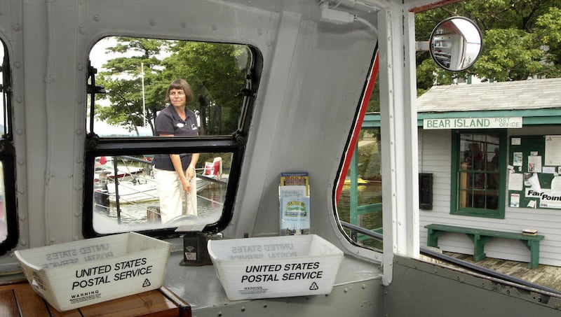 In this photo taken Thursday Sept. 8, 2011, postmistress Anne Nix ties down the M/V Sophie C at Bear Island on Lake Winnipesaukee in Meredith, N.H. The Sophie C is the nation's only inland floating post office. Imagine a nation without the Postal Service.