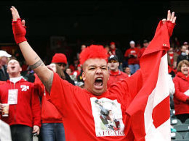 University of Utah fan Nicholas Afeaki helps the Yellow Jackets see red as the Utes batter Georgia Tech at the Emerald Bowl.