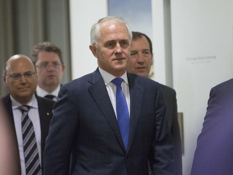Australia\'s former Liberal Party leader and Communications Minister Malcolm Turnbull walks with his supporters to the Liberal Party meeting that will decide the party leadership as well as the prime minister of the nation at Parliament House in Canberra,