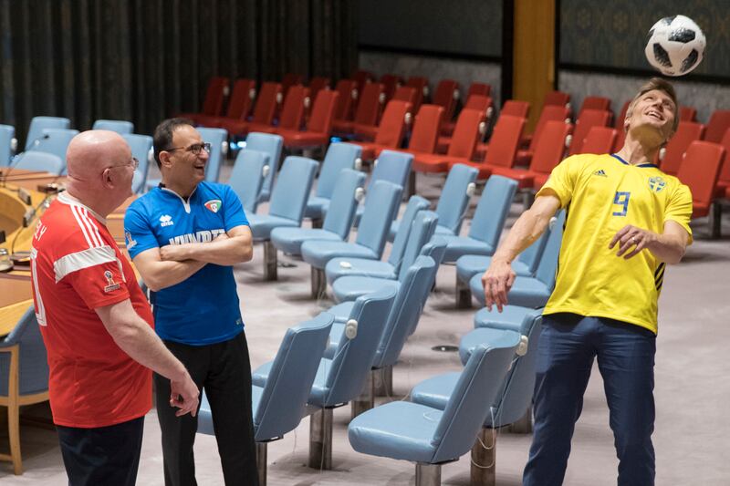 Russian Ambassador to the United Nations Vassily Nebenzia, left, Kuwaiti Ambassador to the United Nations Mansour Ayyad Al-Otaibi, second from left, and Swedish Deputy Ambassador to the United Nations Carl Skau play with a soccer ball while waiting for ot