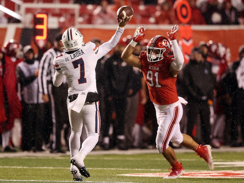 Utah defensive end Gabe Reid pressures Arizona quarterback Jayden de Laura (7) at Rice-Eccles Stadium in Salt Lake City.