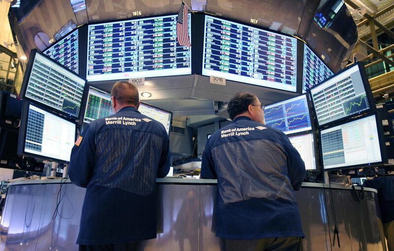 In this Tuesday, Aug. 23, 2011 file photo, Bank of America Merrill Lynch traders work on the floor of the New York Stock Exchange in New York. There are fewer and fewer traders on the NYSE floor because of the dominance of computer trading of securities -