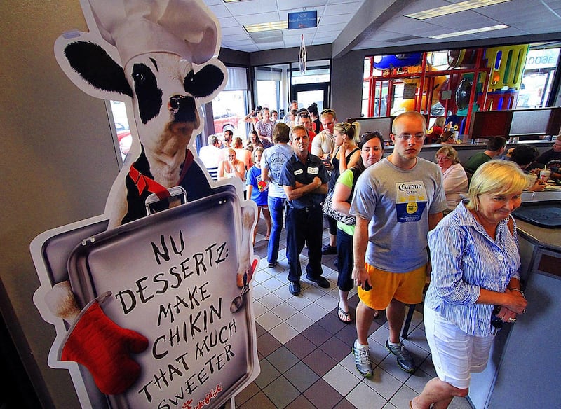 Customers stand in a long line at the Chick-fil-A in Columbus, Ga., Wednesday, Aug. 1, 2012. Chick-fil-A supporters are eating at restaurants in the chicken chain as the company continues to be criticized for an executive\'s comments about marriage and fa