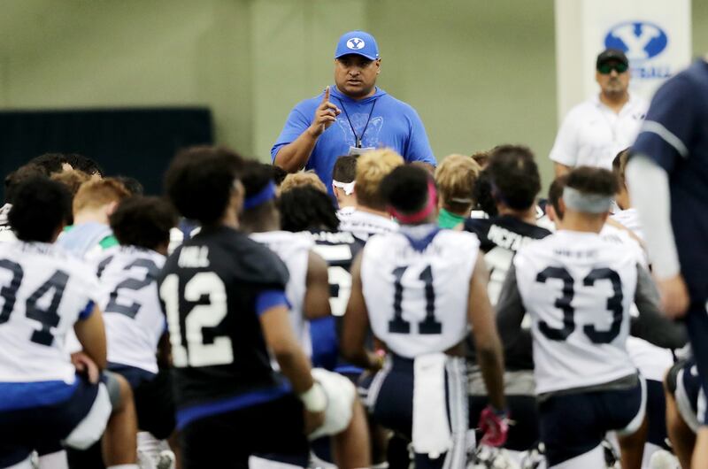 BYU football coach Kalani Sitake talks to his team after BYU opened football practice at the indoor practice facility in Provo on Wednesday, July 31, 2019. Sitake hired Jasen Ah You as his recruiting coordinator recently and Ah You says the Cougars will be more selective than usual during this recruiting cycle due to a relatively small number of available scholarships.