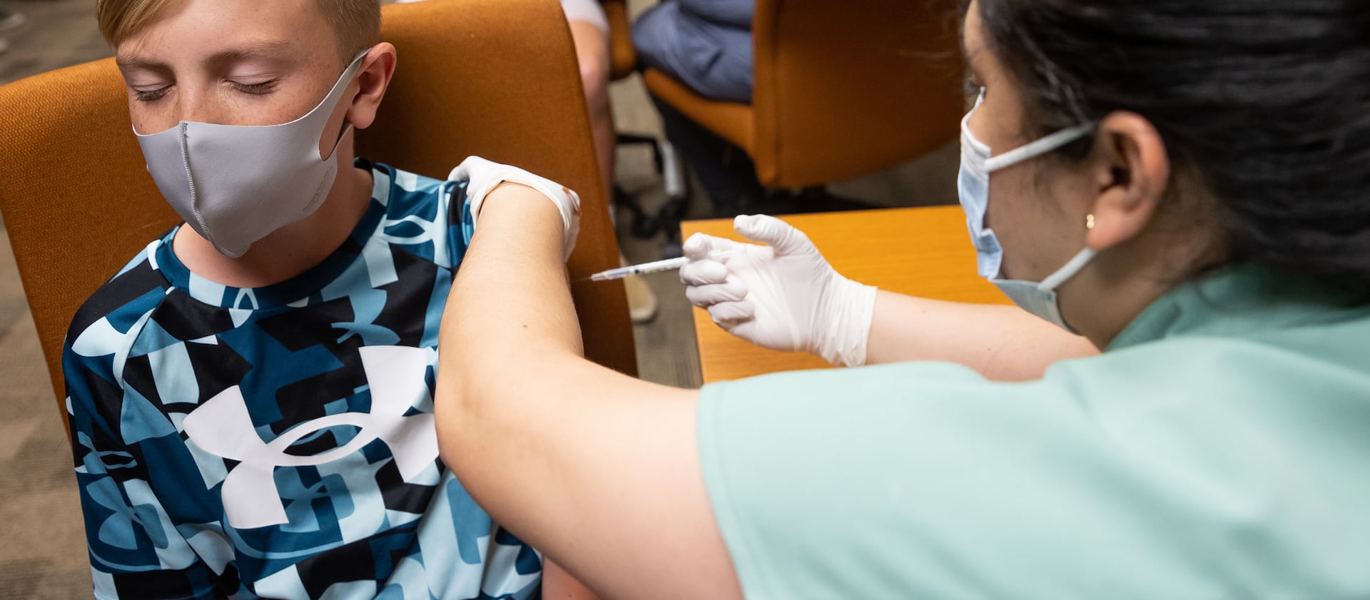 Jack Allen, 12, closes his eyes as he gets a dose of Pfizer-BioNTech COVID-19 vaccine from nurse Estefania Cruz in Kaysville. The Utah Department of Health on Monday reported 1,552 new COVID-19 cases in the state from over the weekend.