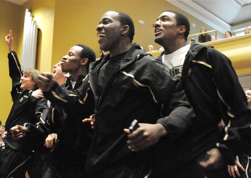 The Wofford College basketball team watches the NCAA bracket pairings for the upcoming tournament at Leonard Auditorium in Spartanburg, S.C., Sunday, March 13, 2011. Tim Johnson, center, and his teammates react to seeing they will travel to Denver to play