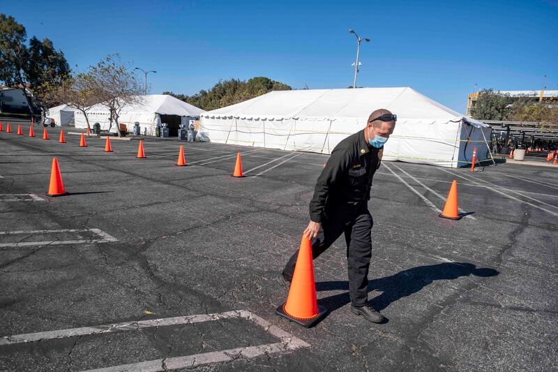 LACO Fire Department Battalion Chief Kevin DeJong helps set up a LA County vaccine distribution Site at California State University Northridge Monday, Jan. 18, 2021.