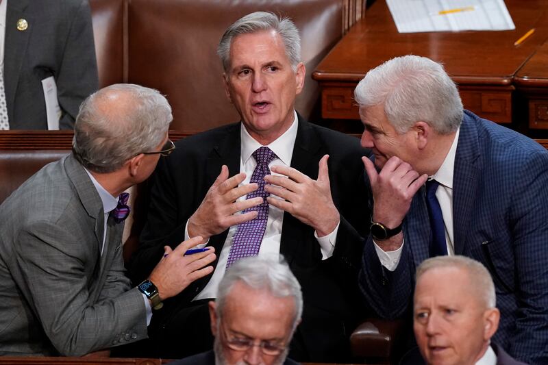 Rep. Patrick McHenry, R-N.C., left, and Rep. Tom Emmer, R-Minn., right, speaks with Rep. Kevin McCarthy, R-Calif., in Washington, Wednesday, Jan. 4, 2023.