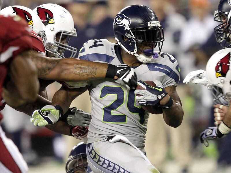Seattle Seahawks running back Marshawn Lynch (24) runs against the Arizona Cardinals during the first half of an NFL football game, Thursday, Oct. 17, 2013, in Glendale, Ariz. (AP Photo/Rick Scuteri)