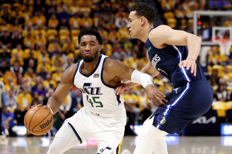 Utah Jazz’s Donovan Mitchell drives around Dallas’ Dwight Powell in Game 4 of a first-round playoff series in Salt Lake City.