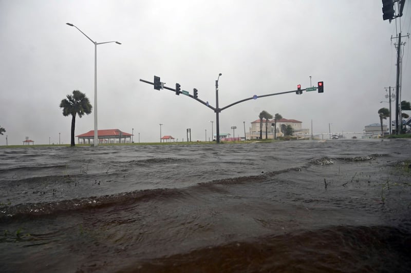 A storm surge covers U.S. 90 in Long Beach, Miss., on the Mississippi Gulf Coast as Tropical Storm Cristobal makes landfall Sunday, June 7, 2020.