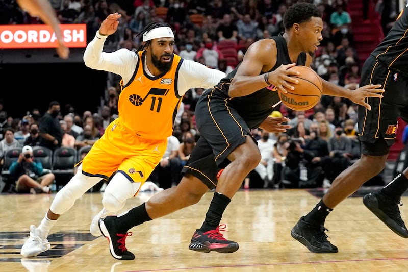 Miami Heat guard Kyle Lowry, right, drives to the basket as Utah Jazz guard Mike Conley defends.