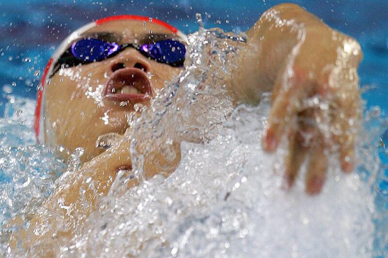 FILE - In this Dec. 5, 2006 file photo, China's Ouyang Kunpeng competes in a Men's 100m backstroke heat at the Asian Games in Doha, Qatar. China is stopping a former Asian record holder from returning to competition even though the World Anti-Doping Agenc