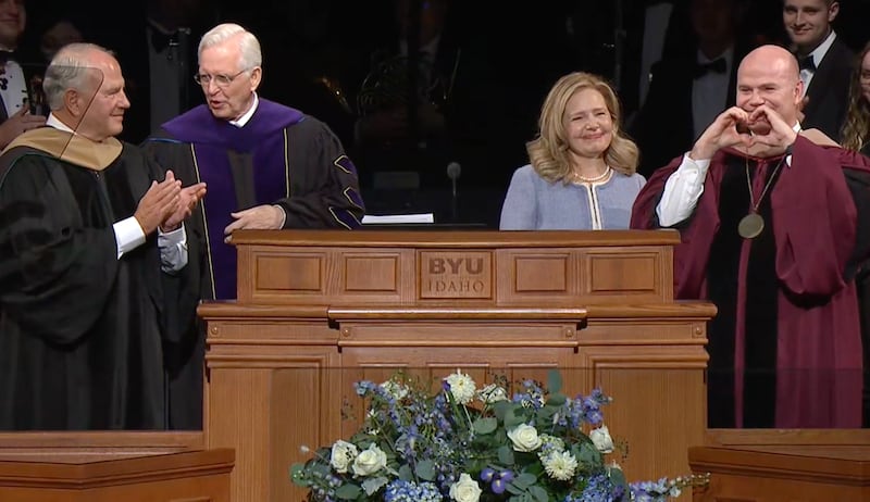 New BYU-Idaho President Alvin F. Meredith makes a heart sign next to his wife, Jennifer, at his inauguration on Oct. 10, 2023.