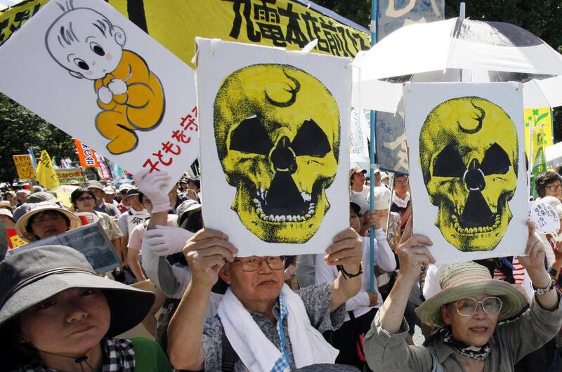 Protesters carry anti-nuclear placards during a march in Tokyo, Monday, July 16, 2012. Tens of thousands of people gathered at a Tokyo park, demanding “Sayonara,” or goodbye, to nuclear power as Japan prepares to restart yet another reactor, and expressed