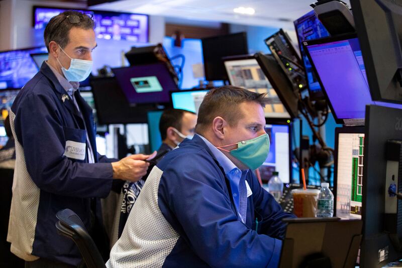 Traders on the New York Stock Exchange react to news the Federal Reserve may raise interest rates this year.