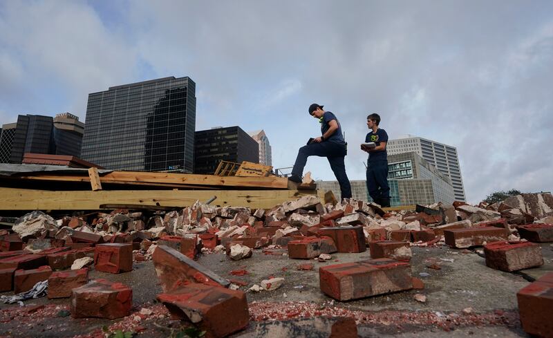 New Orleans firefighters assess damage after a building collapsed from the effects of Hurricane Ida, in New Orleans, La.